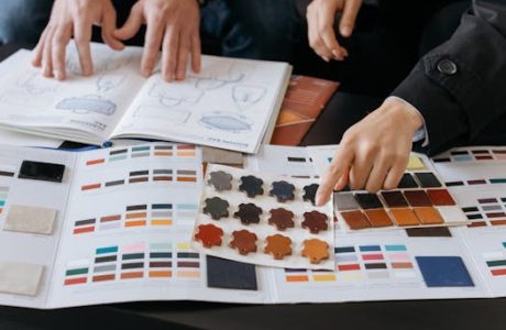 Designers reviewing color swatches and sketches for project planning.